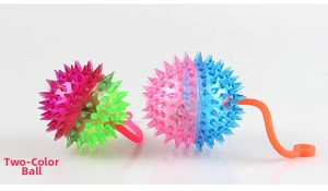 Close-up of two-tone glowing spiked balls with elastic loops and soft massage texture