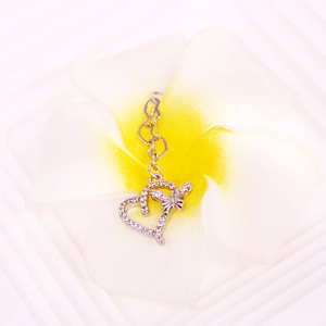 Silver heart and butterfly nipple ring with micro-paved zircons on a white flower
