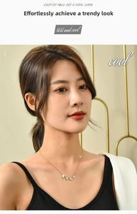 Detailed view of a versatile clover heart necklace worn by a model in a golden finish