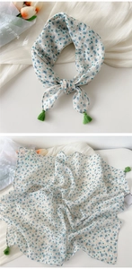 Detail of cotton linen scarf with blue paisley print and green corner tassels