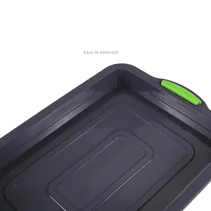 Non-stick brownie cake pan with green silicone handles for easy demoulding baking