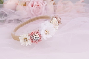 Detailed view of baby floral headband with pink and white fabric flowers and mesh