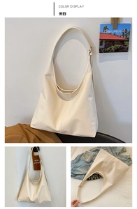 Detailed close-up showing the minimalist off-white PU leather hobo bag textures