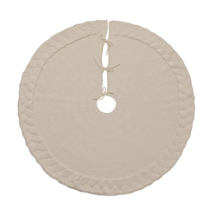 Beige knitted Christmas tree skirt with classic cable weave and ties on white background