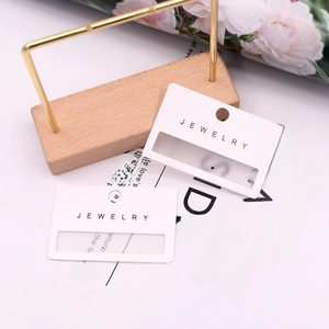 White PVC jewelry display cards with six holes for earrings and hanging slot design