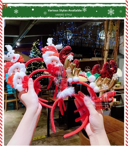 Close-up of festive Christmas headbands featuring reindeer antlers and Santa Claus motifs