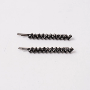 Pair of minimalist black metal hair pins featuring elegant double rows of dark rhinestones