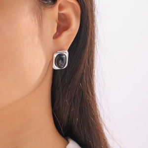 British style silver titanium steel stud earring with inlaid black glass on model