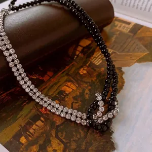 Double-layered beaded choker necklace with sparkling diamonds and black pearl accents