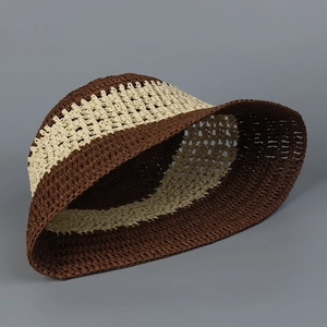 Detail of handmade crochet bucket hat with dark brown and beige stripes for summer