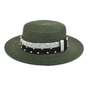 Detail of green straw boater hat with pearl and rhinestone ribbon embellishments