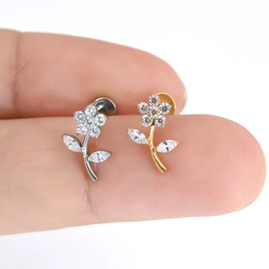 F136 titanium zircon rose flower stud for ear and lip piercing shown on a fingertip