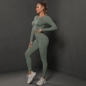 Sage green yoga set detail showing long sleeve crop top with thumbholes and ribbed texture