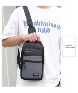 Detailed view of the gray and black oxford fabric sling bag worn across the chest