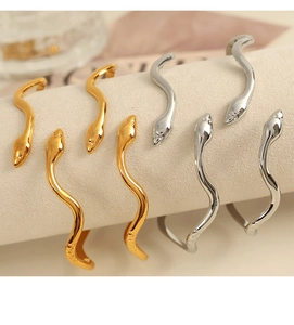 Detail showing the snake-shaped bangle with refined metallic texture and curved design