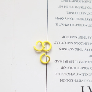 Detailed view of three small yellow metal jump rings for DIY jewelry making and crafts