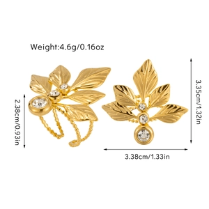 Detailed view of gold leaf earrings with sparkling rhinestones and natural texture