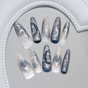 Handmade cat eye press on nails with silver butterfly and moon charms in stiletto shape