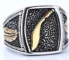 Detailed close-up of retro punk ring with gold scimitar and feather engraving details