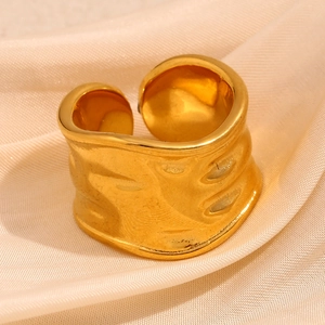 Irregular textured wide open ring in 18K gold plated stainless steel on silk