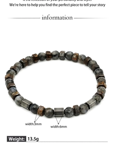 Macro detail of men's beaded bracelet with tiger eye stones and metallic spacers