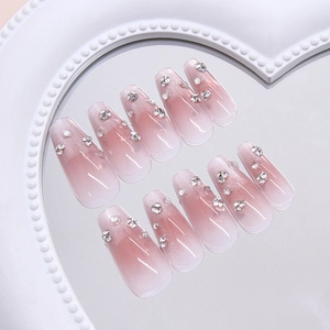 Pink ombre cat eye press-on nails with sparkling rhinestones in ballerina coffin shape