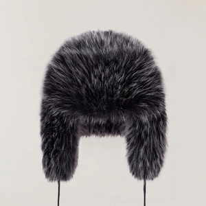 Macro shot of fluffy dark grey faux fur texture and long pile on winter ushanka hat