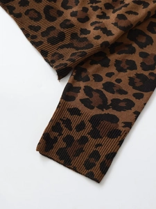 Macro detail of leopard print knit sweater with ribbed cuffs and textured fabric