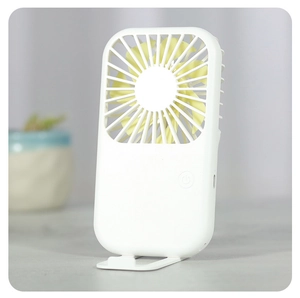 Detail view of portable mini USB fan with white body, yellow blades, and desktop stand