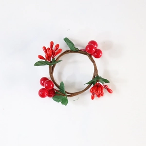 Christmas berry napkin ring with red berries and green silk leaves on a rattan base