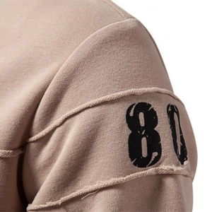 Close-up of khaki sweatshirt featuring shoulder seam detail and printed number 80 design