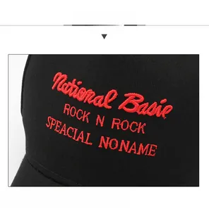 Detailed close-up of red National Basic embroidery on a black cotton five-panel baseball cap