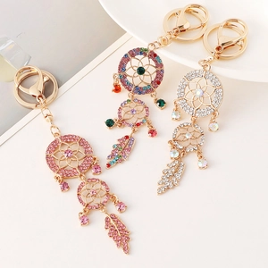 Sparkling rhinestone dreamcatcher keychains in pink, multi-color, and white gold finishes