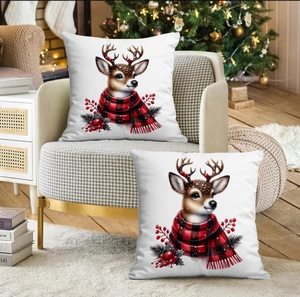 Détails de deux housses de coussin de Noël avec cerf et écharpe rouge sur un fauteuil