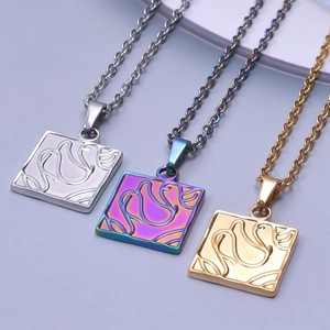 Detail of square swan engraved pendants in silver, gold and iridescent finishes