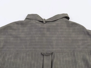 Close-up of grey striped shirt yoke showing fine fabric texture and neat stitching