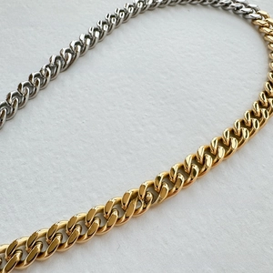 Close-up of 9mm two-tone gold and silver Cuban chain with polished stainless steel link detail
