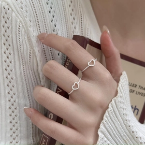 Minimalist 925 sterling silver heart-shaped open ring worn over a cozy knitted sweater