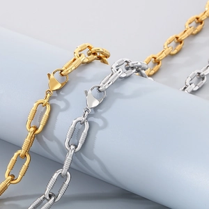 Detailed close-up of gold and silver textured oval link chains with lobster clasps