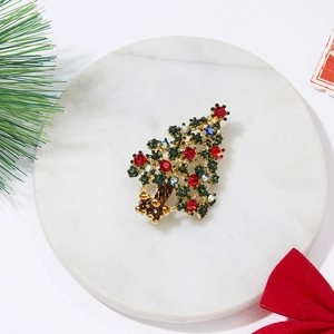 Fashionable Christmas tree brooch with colorful rhinestones on white marble base