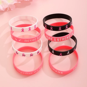Pink, black and white silicone bracelets with Hope Strength phrases for breast cancer awareness