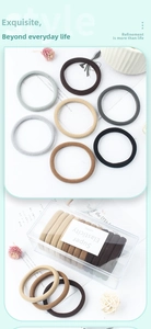 Detail of seamless high-elastic hair ties in earth tones with transparent storage box