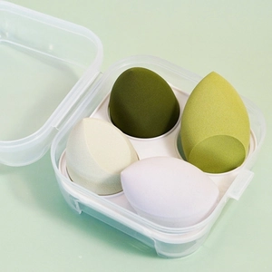 Transparent case with four green, beige and white teardrop makeup sponges set