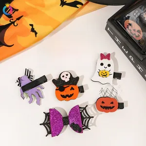 Detail of Halloween hair clip set featuring glittery ghost and pumpkin designs
