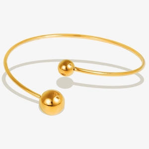 Detail of minimalist 18k gold plated stainless steel open bangle with polished beads