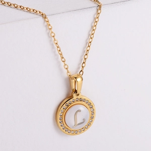 Gold letter L necklace with sparkling rhinestones and cat eye stone on white background
