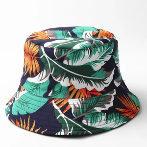 Detailed view of navy tropical leaf print bucket hat with vibrant orange and green foliage