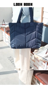 Gesteppte Nylon-Einkaufstasche in Dunkelblau mit V-Muster, von Model im Freien gehalten