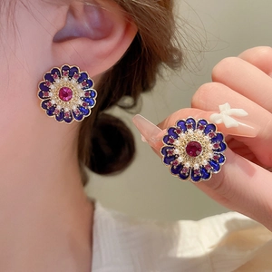 Vintage floral enamel earrings with blue petals and purple crystal in a retro style