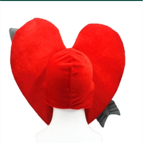 Detail of red plush heart hat with a gray arrow through it for party costume use